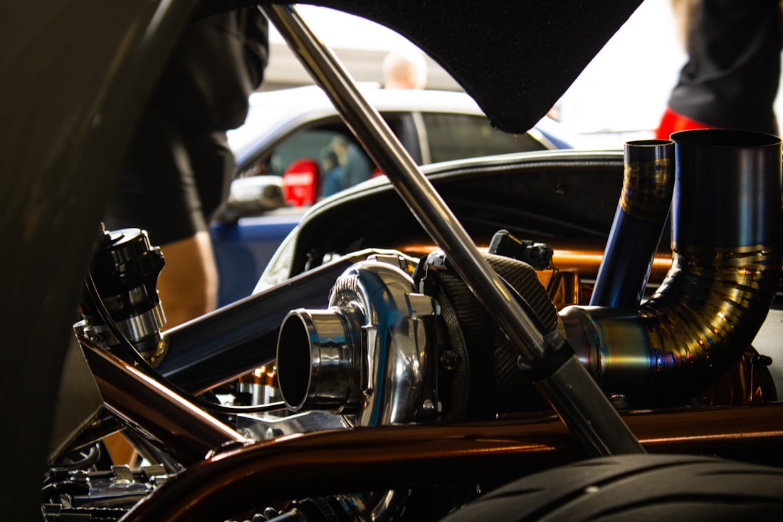 Intake and exhaust breathing hardware in the engine bay — Stage 2 supporting upgrades